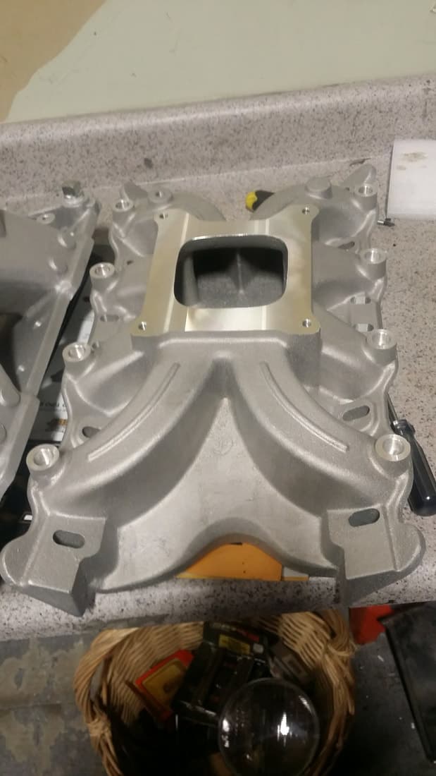 Bare aluminum intake manifold on the bench